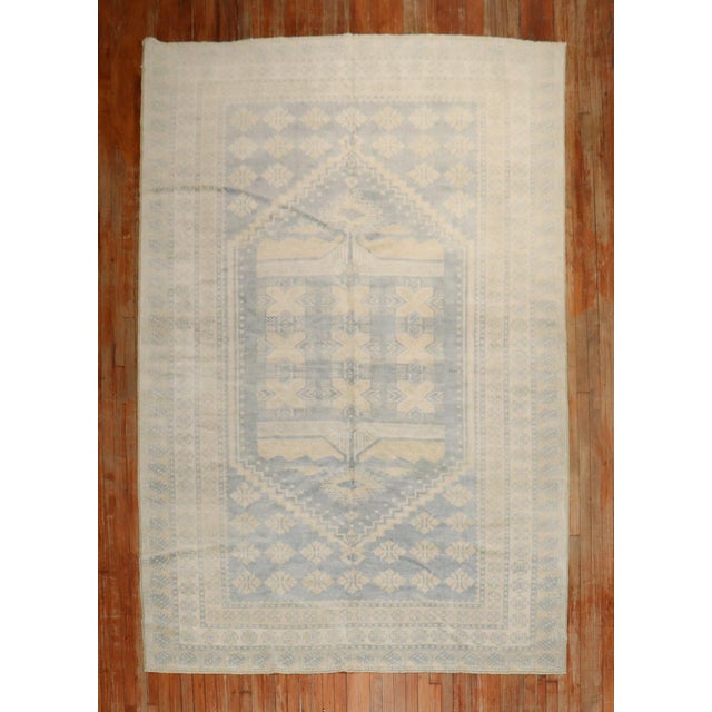 A Mid 20th Century Turkish Rug in predominantly soft yellow and blue Measures: 6'10'' x 9'8''