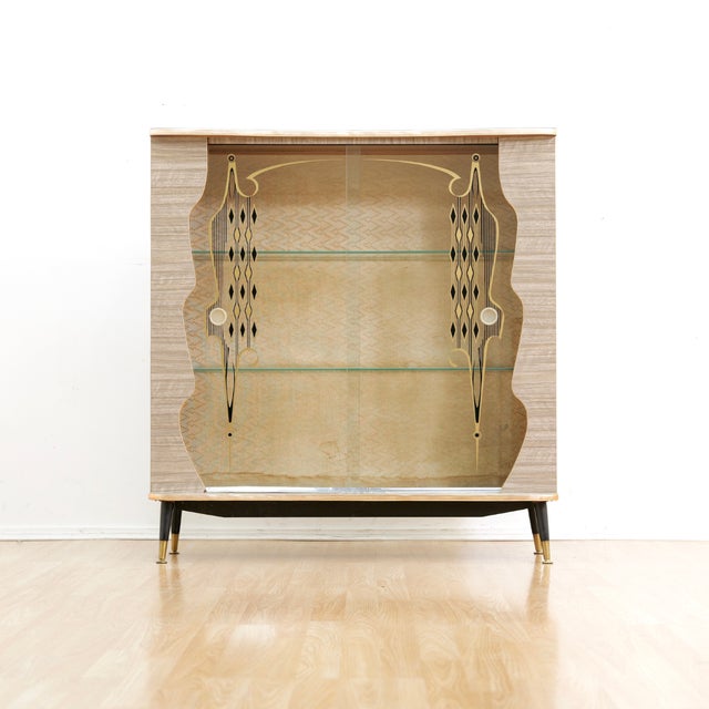 This fabulous mid century 'atomic' curio cabinet is a wonderful 1950s design and excellent storage piece. With melamine...
