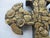 Traditional Mexican folk art Milagros cross featuring a hand-carved dark wood base densely embellished with hammered gold-...