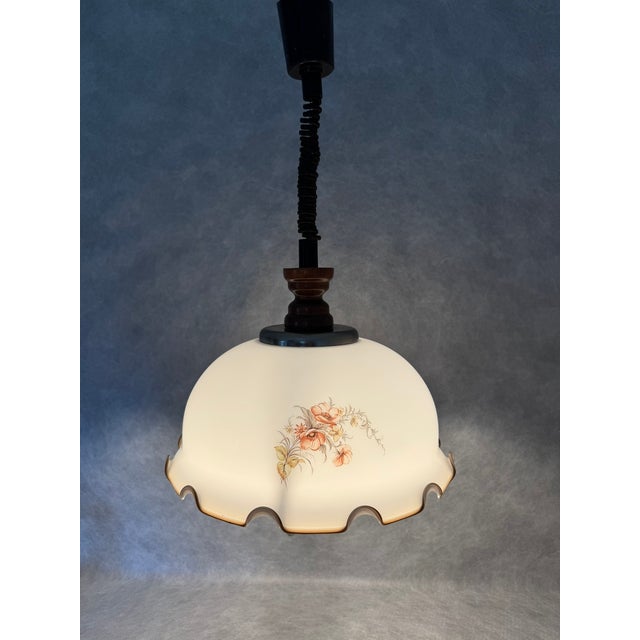 Italian pendant lamp from the 1970s featuring a scalloped opaline glass shade with floral motif. The lamp has an...