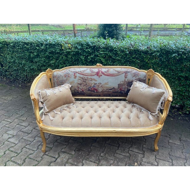 A magnificent 1940s French Louis XVI-style salon set, comprising one sofa and four matching armchairs. This elegant...