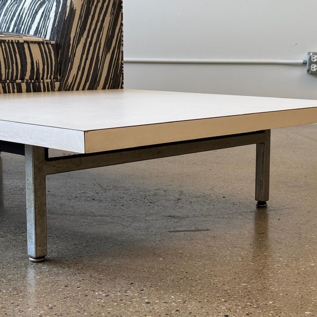 c. 1950s. USA. Reupholstered in Pierre Frey “Bourail” Jacquard fabric. Refoamed as well. White laminate side tables with...