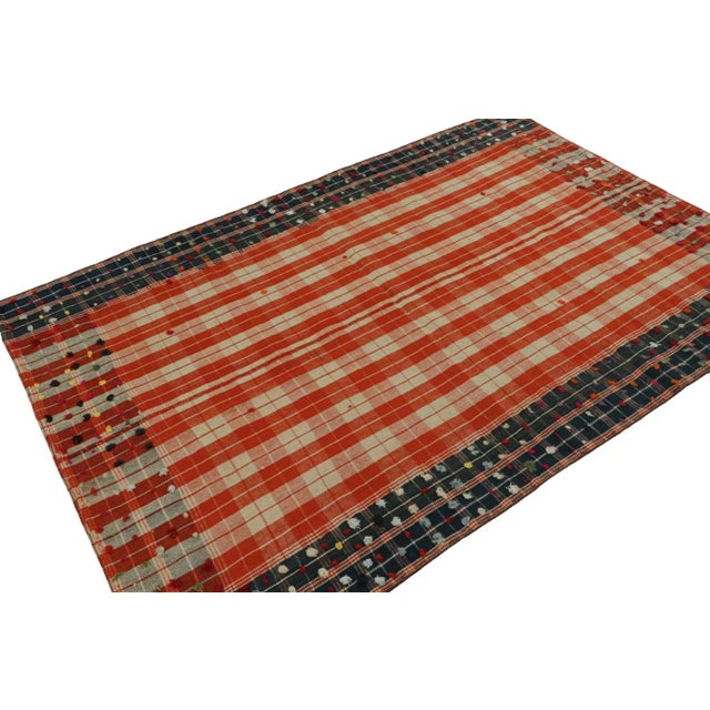 Featuring a colorway of red, blue and off-white, this 5x7 vintage Afghan tribal kilim rug, handwoven in wool, circa...
