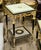 A beautifully detailed French Louis XVI-inspired side table featuring a striking black and white finish accented with...