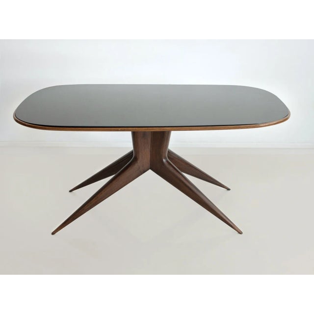 Rectangular dining table with rounded corners, manufactured in Italy, circa 1950. Structure made of wood, slender legs,...