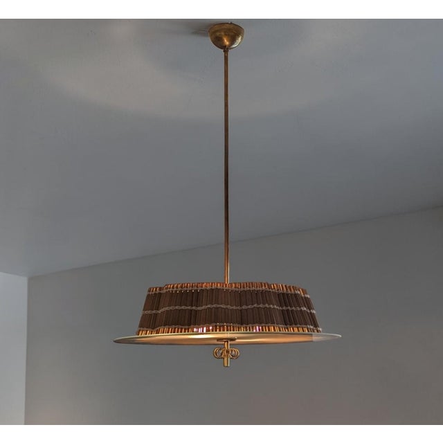 This ceiling lamp, designed by Paavo Tynell in the late 1940s, is a sophisticated example of Finnish post-war design,...