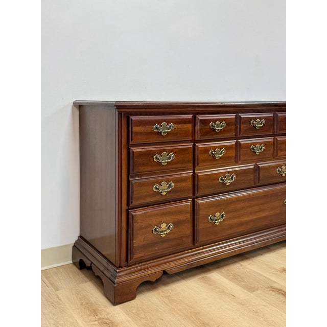 This handsome vintage American Drew nine drawer lowboy dresser is a well-crafted and generously proportioned bedroom...