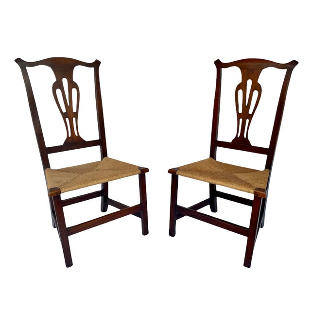 A beautiful pair of country Chippendale style chairs in mahogany, circa 1780. Each chair features a decorative pierced...