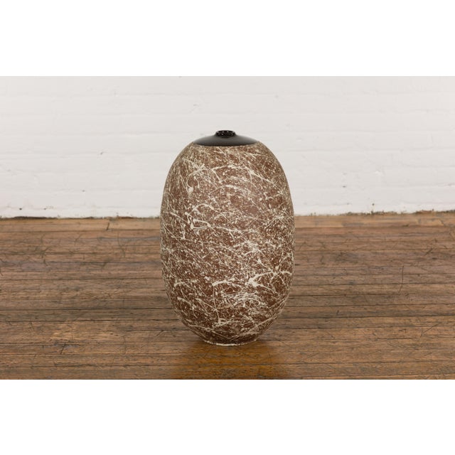 A large contemporary Prem Collection artisan hand crafted ceramic vase or object with narrow mouth, brown ground,...