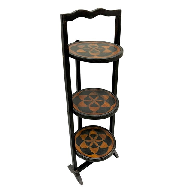 A wonderfully unusual antique English folk art tray table featuring three individually mounted circular trays decorated...