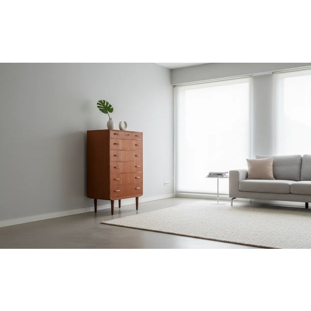 Elegant six-drawer chest crafted in teak and produced by Ølholm Møbelfabrik in Denmark during the 1960s. This piece...
