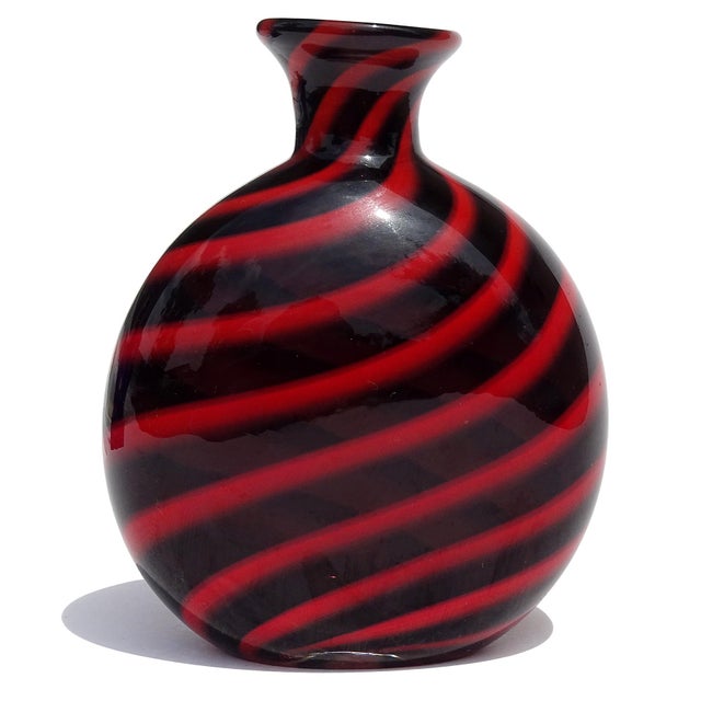 Beautiful vintage Murano hand blown black and ruby red swirl Italian art glass flower vase. The piece documented to...