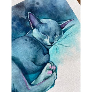 Nestled in Blue by Chris Hong | Watercolour on paper of a sleeping blue cat For Sale
