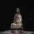 This elegant sculpture depicts Guanyin, the Bodhisattva of compassion, seated in a meditative lotus position. The figure...