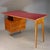 Double-sided desk with an elegant asymmetrical design from the 1950s. Solid teak frame, burgundy red glass top (RAL 3004),...