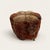 A little footstool covered in a piece of a genuine hand-knotted Oriental carpet, the pile worn down over a century of use...
