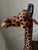 Oversized handcrafted giraffe sculpture wrapped in hand-applied leather with painted detailing. This striking piece stands...