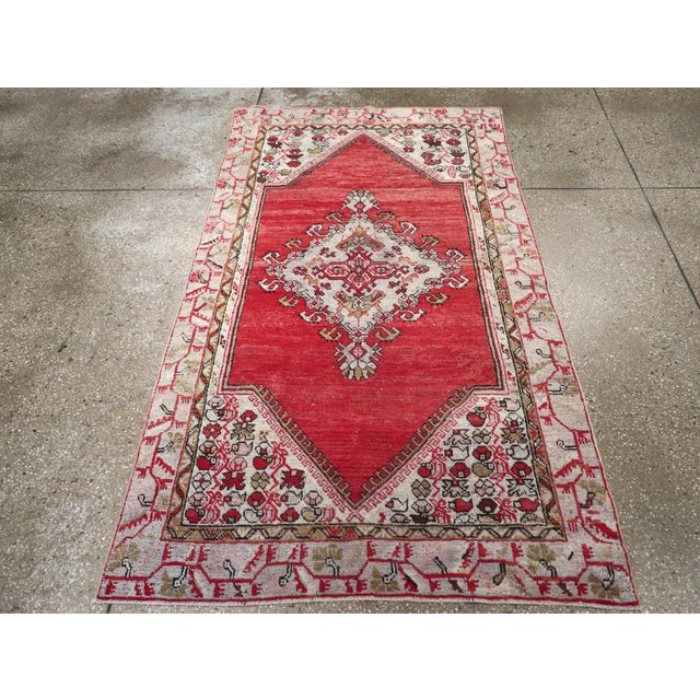 A vintage Turkish Oushak accent rug. This Turkish scatter has a variegated brown open field displaying a pendant diamond...