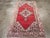 A vintage Turkish Oushak accent rug. This Turkish scatter has a variegated brown open field displaying a pendant diamond...