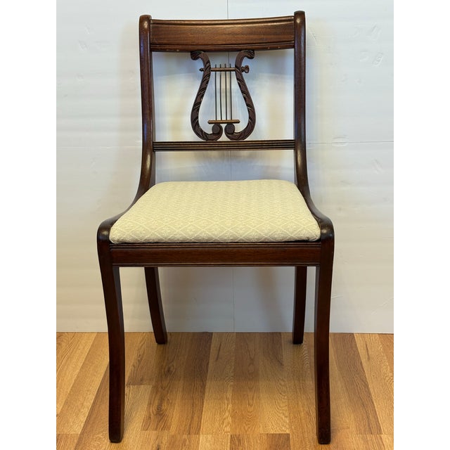 Add classical elegance to your space with this handsome pair of vintage Duncan Phyfe style side chairs from the 1940's....