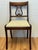 Add classical elegance to your space with this handsome pair of vintage Duncan Phyfe style side chairs from the 1940's....