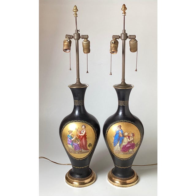 A Pair of Hand Painted neoclassical French Porcelain lamps. The porcelain urns with gilt cartouches depicting Greek Muse's...