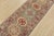 A tribal Caucasian Kazak runner hand-knotted with fine wool on a cotton foundation. This rug features a row of geometric...