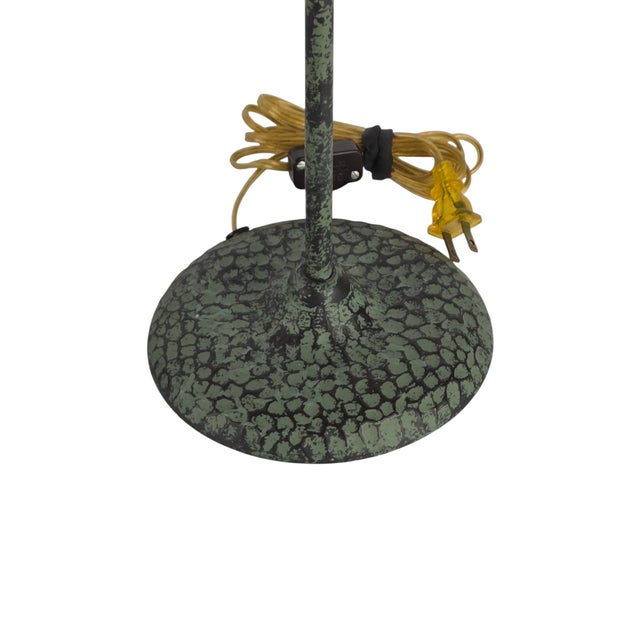 Substantial pair of cast metal buffet candlestick lamps in a verdigris bronze finish, attributed to Frederick Cooper. The...