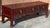 A l19th Century Chinese Rouge Lacquered and carved Elmwood three drawer Kang Table. Measures 48" in width, 14" in depth,...