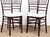Chic Set Of Four Faux Bamboo Wooden Chiavari style Chairs. Bamboo spindle style back, solid wood seat. Legs are joined...