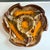 A wonderfully sculptural vintage California pottery serving dish featuring an expressive orange, brown, yellow and earth-...
