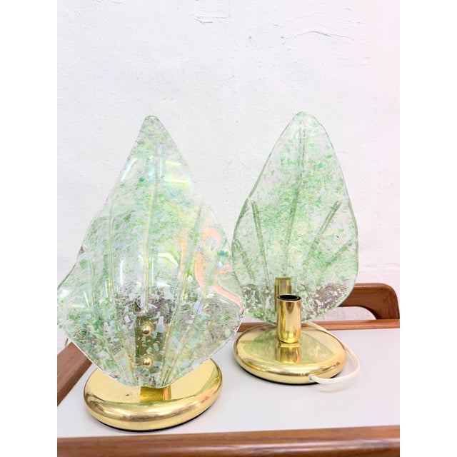 Two Italian (likely) table lamps from the 1970s, single-bulb, E14 socket. Brass base. Removable leaf-shaped shades made of...
