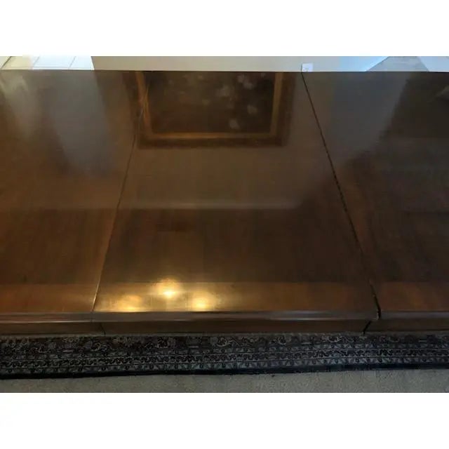 Henredon Wooden Dining Table. This Table was Acquired in North Carolina, USA. It is of a Mahogany Brown Color and has a...
