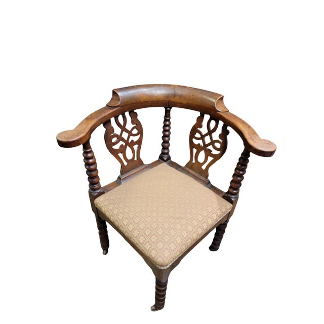 An English Victorian Walnut Bobbin turned corner chair, with fretted back splats on original castors.