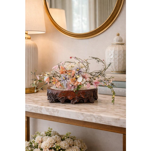 Decorative Chinese hardstone-style floral sculpture with pastel stone blossoms on a carved-look root base. Sculptural and...