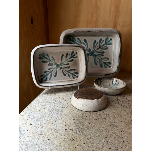 A striking collection of handcrafted studio pottery attributed to Gerard Hofmann, combining sculptural simplicity with...