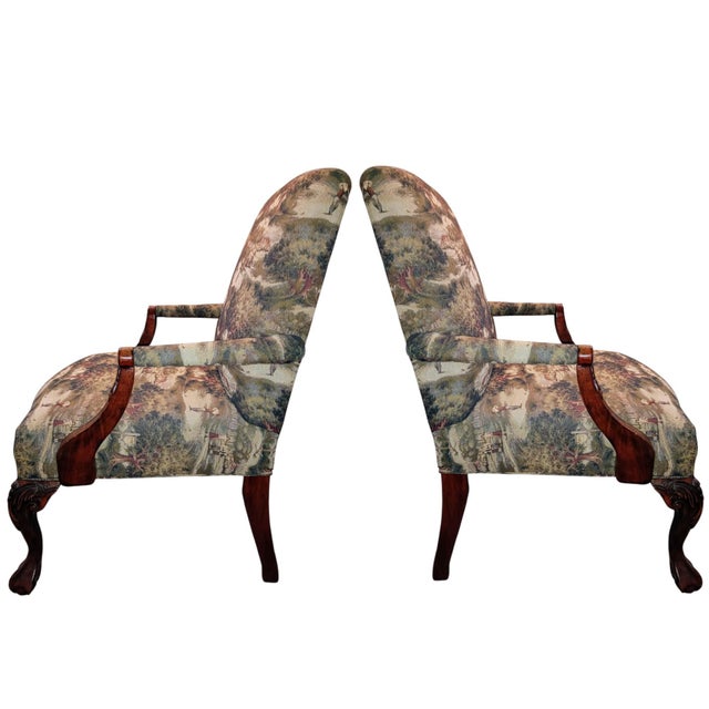 Two Georgian-Style Mahogany Armchairs: Hand-carved solid mahogany frames featuring elegant cabriole front legs and...