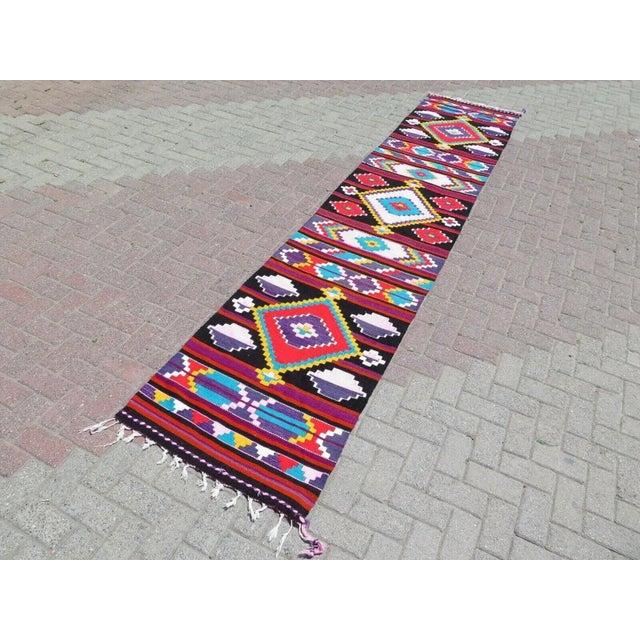 This beautiful, traditional vintage, flatweaved Turkish kilim rug is approximately 60 years old. It is handmade of very...