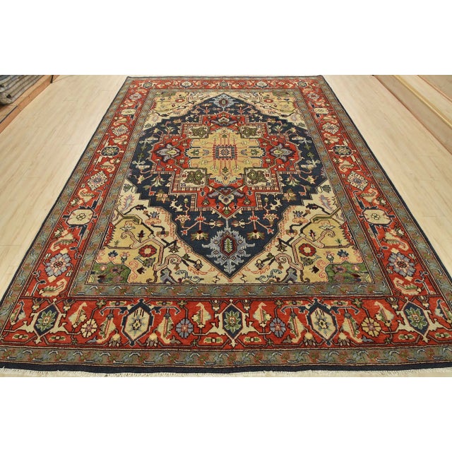 This traditional tribal Serapi rug is hand-knotted with an all-wool pile on a cotton foundation. This rug is new and in...