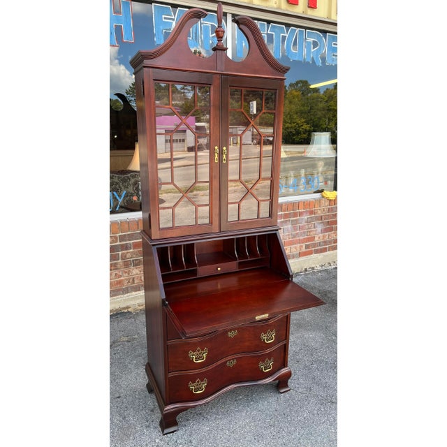 Beautiful solid cherry secretary by Jasper Cabinet Company. Serpentine front. Bracket feet. Polished brass hardware....