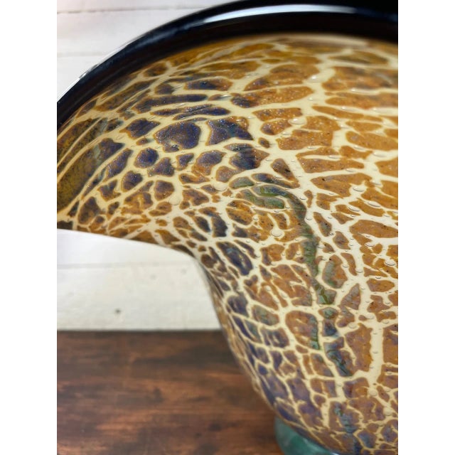 Studio Glass Bowl. This studio glass Leopard patterned bowl has a tan or beige background and interior surface with...