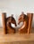 A gorgeous handcarved team of horses. One male and one female each carved out of a rich caramel colored wood.