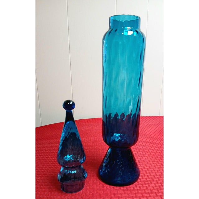 This beautiful turquoise blue, rocket shaped apothecary jar, has a circus tent lid and opic ribbed design body. Very...