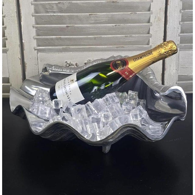 A striking oversized champagne and wine cooler cast in aluminium in the form of an open clam shell. Inspired by natural...