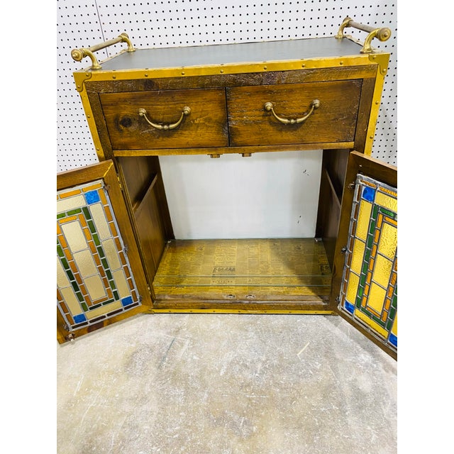 This is a vintage rustic two door stained glass cabinet by Habersham. This cabinet features two doors that have stained...