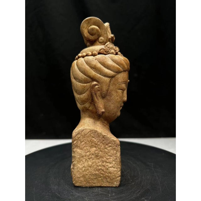 A finely carved Chinese stone sculpture depicting a serene Buddha head inspired by the artistic traditions of the Mogao...