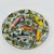 Five individually detailed fish swim through a dense tangle of spiky serrated foliage and yellow blossoms across the...
