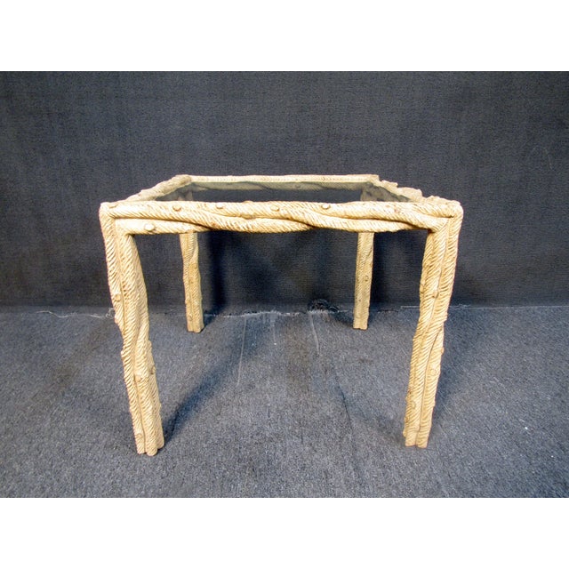 Glass side table featuring a unique faux wood twist frame and glass top. An interesting piece that would pair well with...