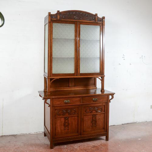 This imposing two-piece sideboard, dating back to the late 19th century, is an antique piece that expertly combines...
