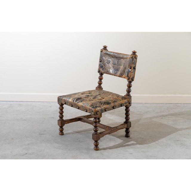 Small Castilian-style dais chair made of walnut wood with turned details. H-shaped frame and crossbar. Seat and backrest...